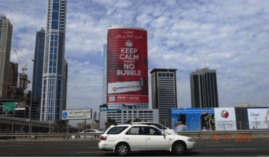 A glass billboard in Dubai with an image of a woman with flowers in her hair